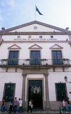 The Leal Senado Building (Portuguese for Loyal Senate) was the seat of Macau's government during its time as a Portuguese colony. The building itself was erected in 1784, and was built in a style similar to Plain style from 14th to 15th Century Portugal.<br/><br/>

Macau was both the first and last European colony in China. In 1535, Portuguese traders obtained rights to anchor ships in Macau's harbours and to trade, though not the right to stay onshore. Around 1552–53, they obtained permission to erect temporary storage sheds on the island and built small houses. In 1557, the Portuguese established a permanent settlement in Macau, paying an annual rent of 500 taels of silver.<br/><br/>

Macau soon became the major trafficking point for Chinese slaves, and many Chinese boys were captured in China, and sold in Lisbon or Brazil. Portugal administered the region until its handover to China on 20 December 1999. It is now best known for casinos and gambling.